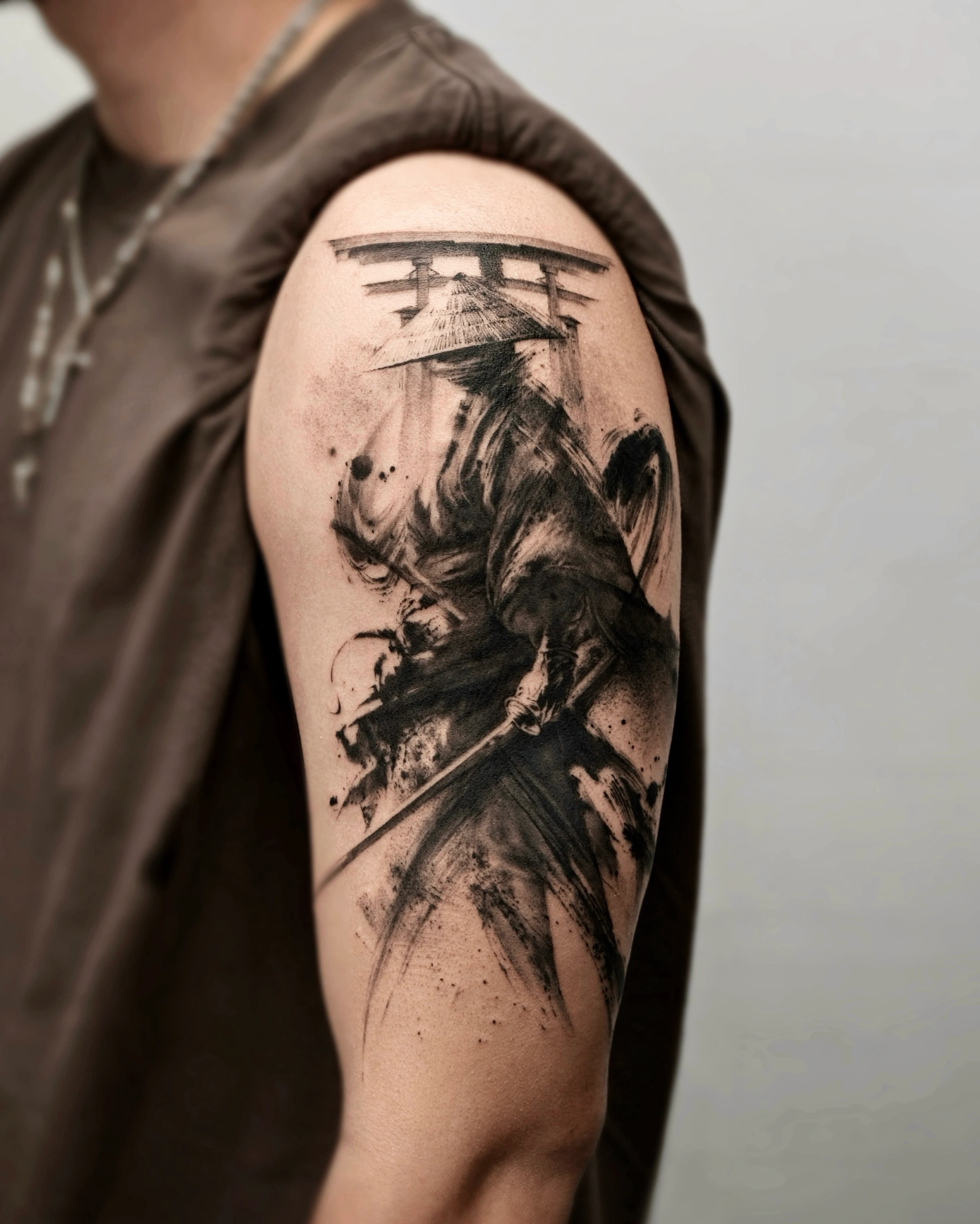 Detail angle of the samurai tattoo showing the calm stance and ink strokes
